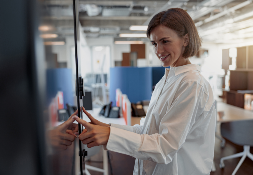 Smiling woman checking into meeting room