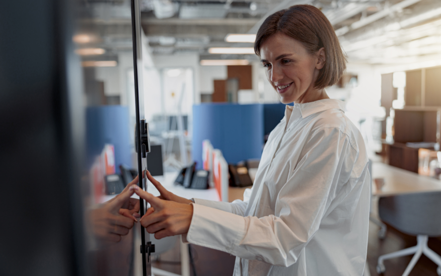 Smiling woman checking into meeting room